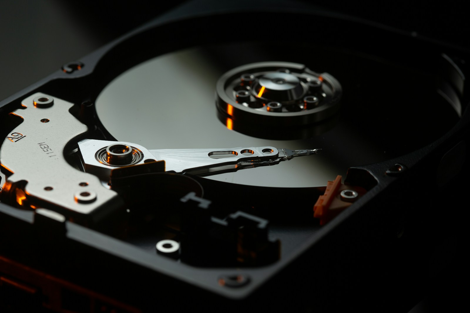 Inside a hard drive showing read/write head and platter — used for data recovery in Perth