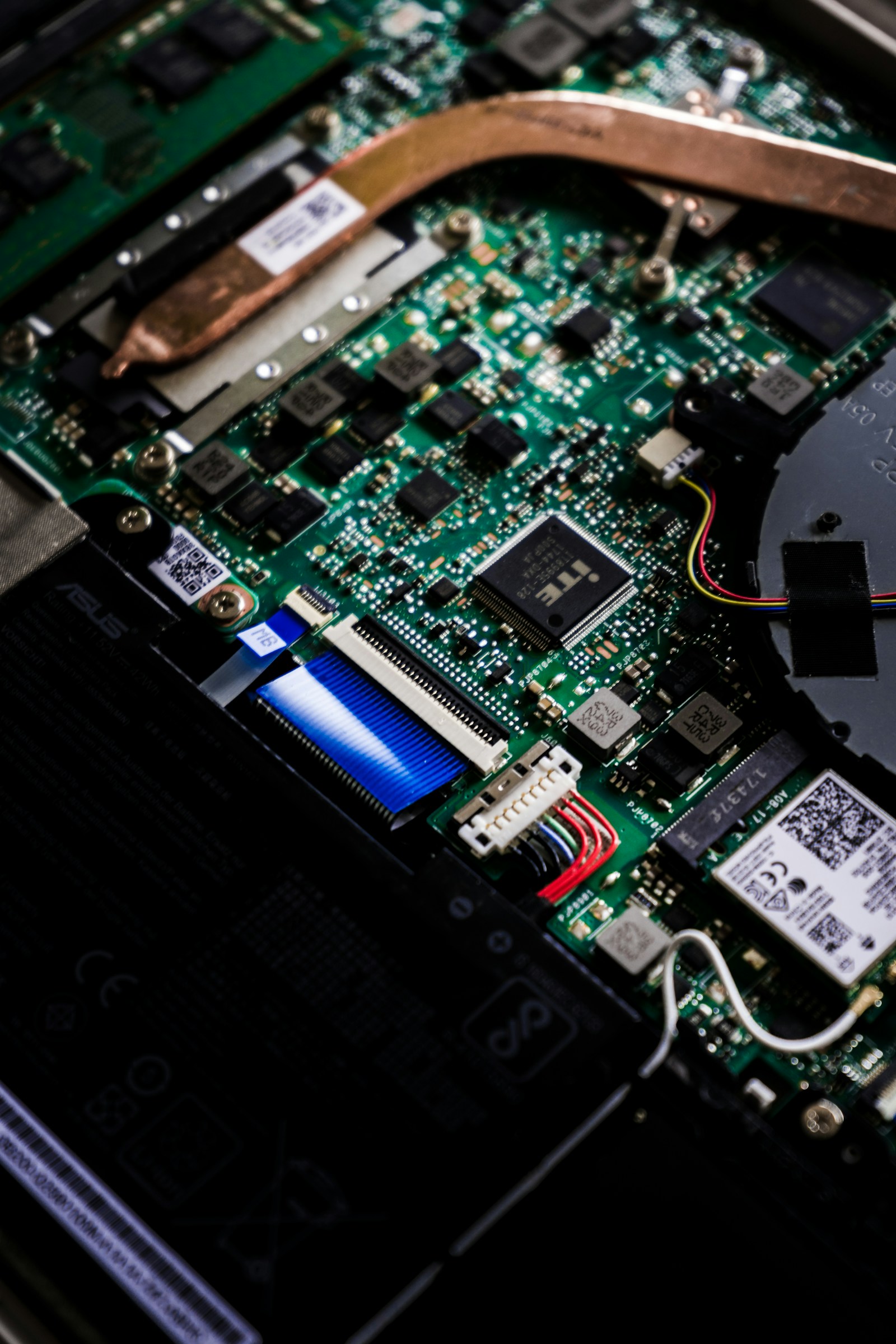 Laptop motherboard with heat pipe and components exposed during an Acer repair in our Perth workshop